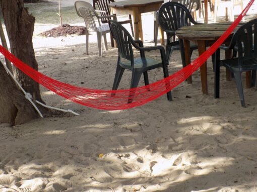 Tables, chairs and swing on beach